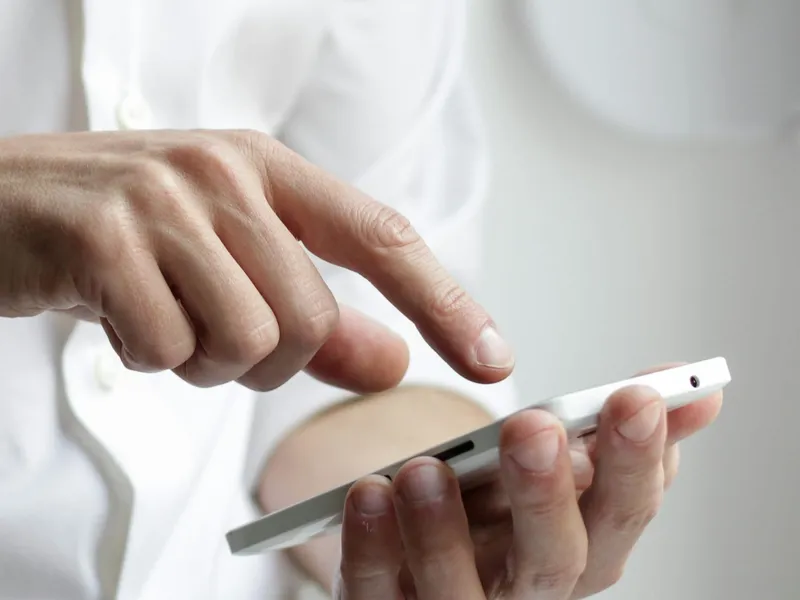 Hands booking a visit on a phone