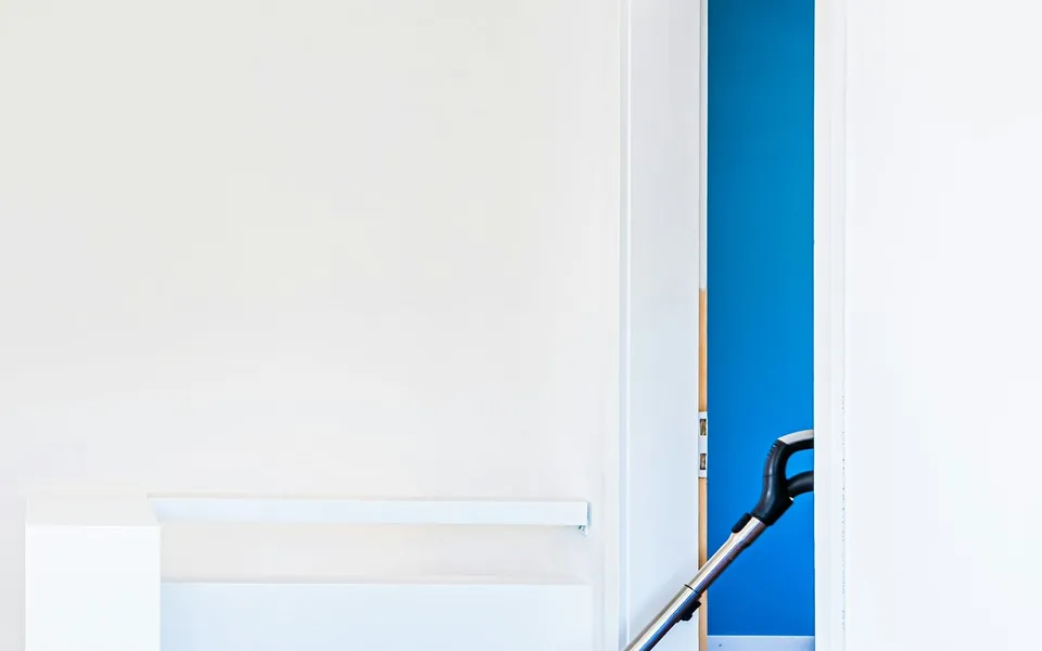 A carpet being cleaned with an extraction wand