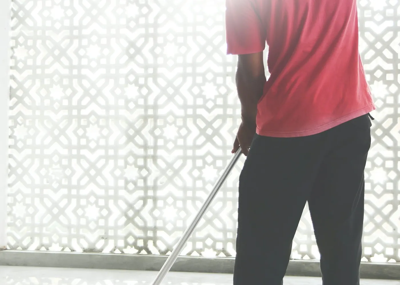 A cleaner mopping a bright floor