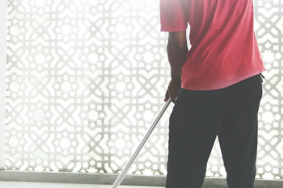 A crew member mopping a bright floor