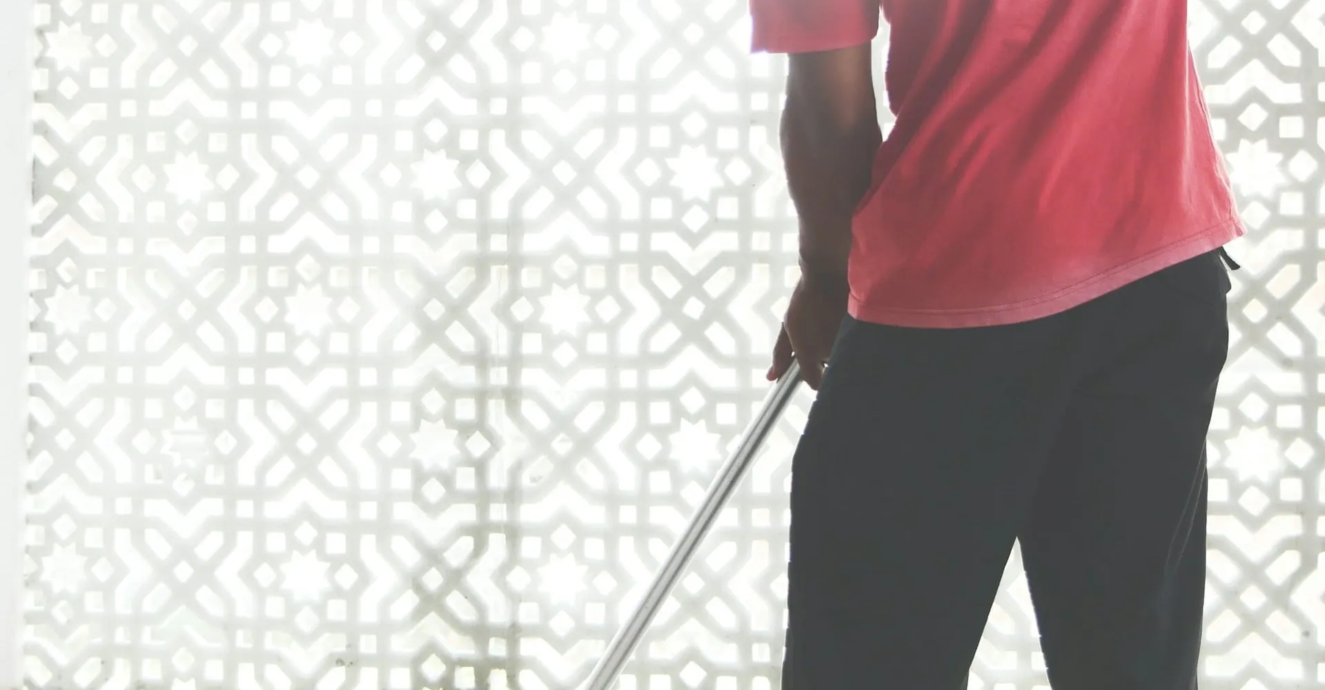 A cleaner mopping a bright office floor