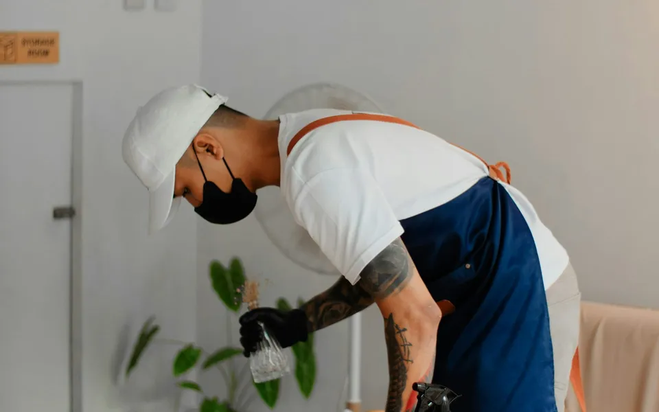 A crew member wiping down a table