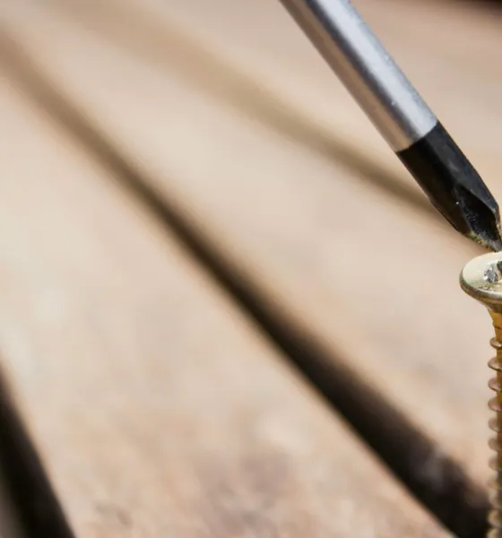 A screwdriver turning a wood screw