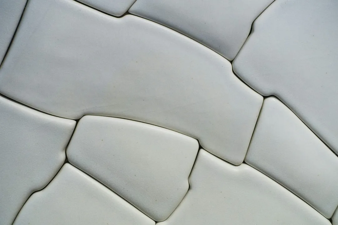 Close-up of white wall tiles and the grout lines between them