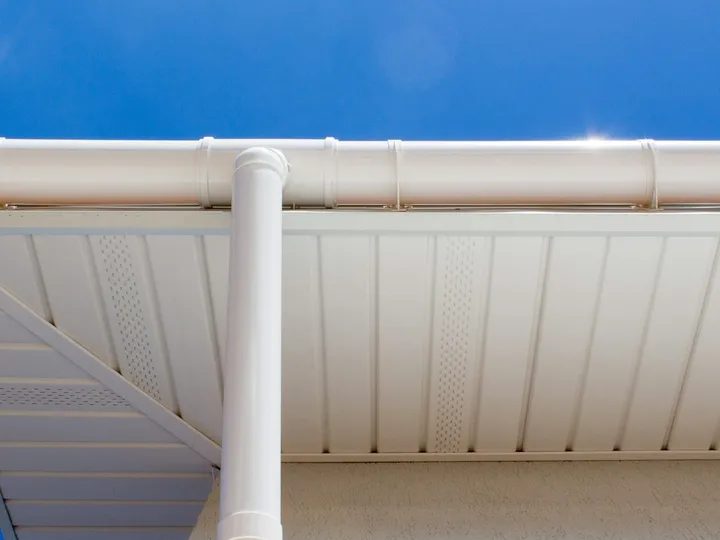 A clean white gutter under a blue sky