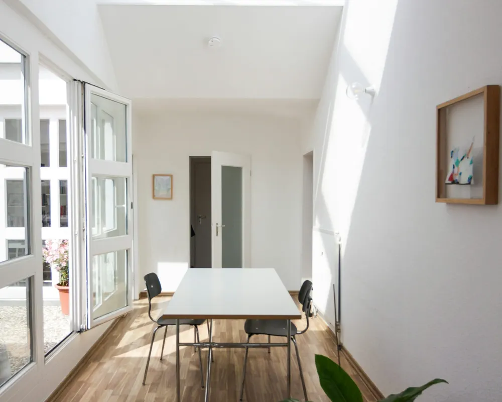 A bright office corridor under a skylight after the evening clean