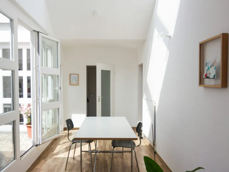 A bright office corridor under a skylight after the evening clean