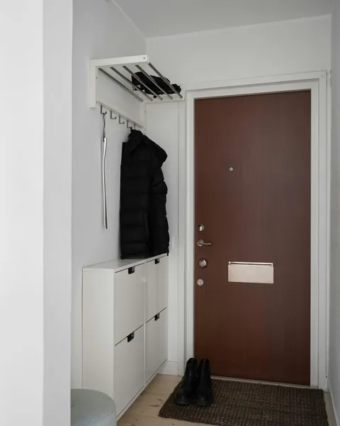 Keys on a hook and shoes on a rack by the front door