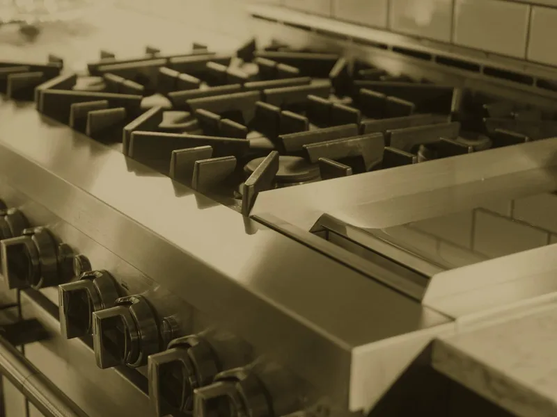Range before: grates and steel trim dulled by grease. The same range after: grates and trim degreased
