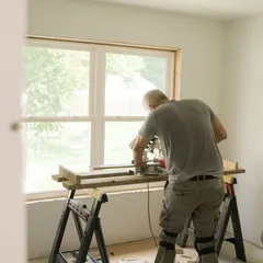 A pro cutting trim at a saw bench