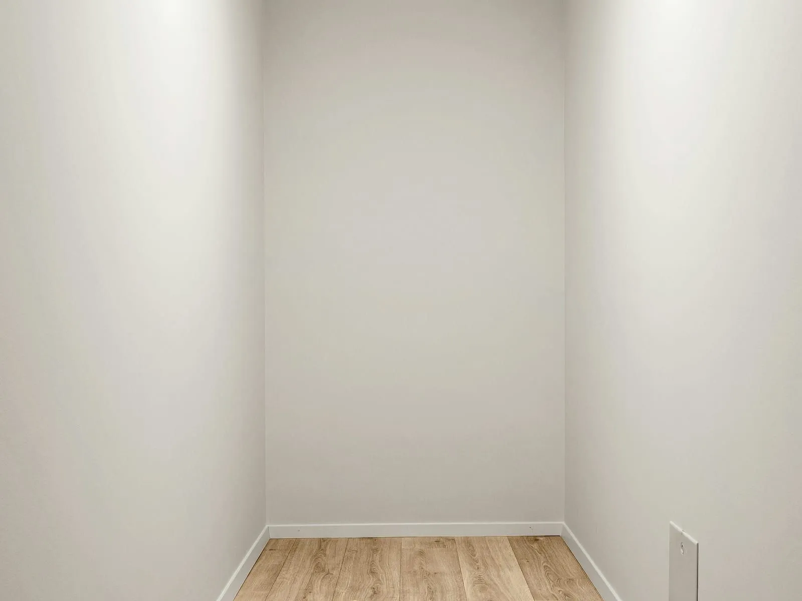 The same room after: clean walls and skirting, floor vacuumed and damp-mopped