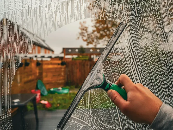 A squeegee clearing a wet window